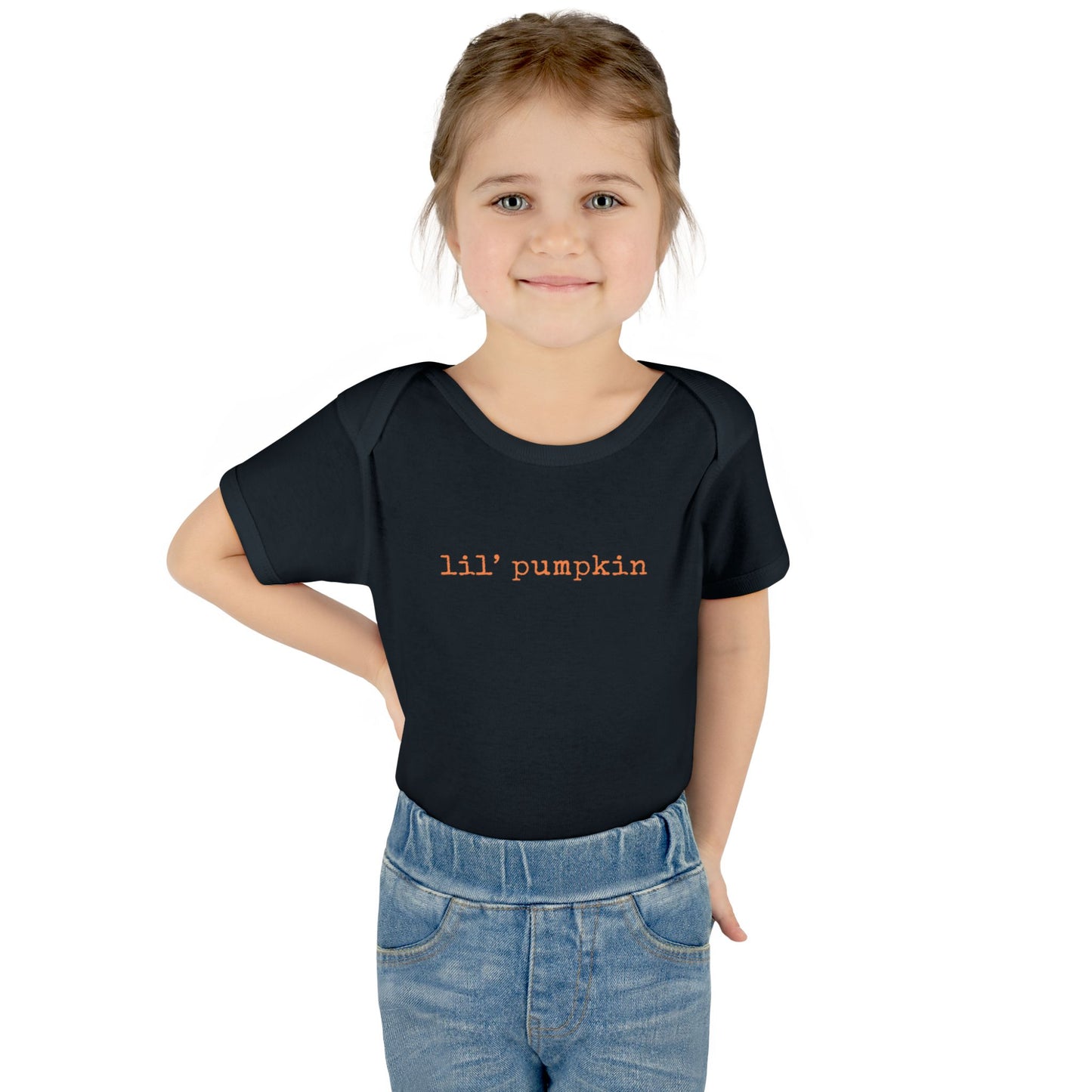 Child wearing a black t-shirt with 'lil' pumpkin' text on a white background