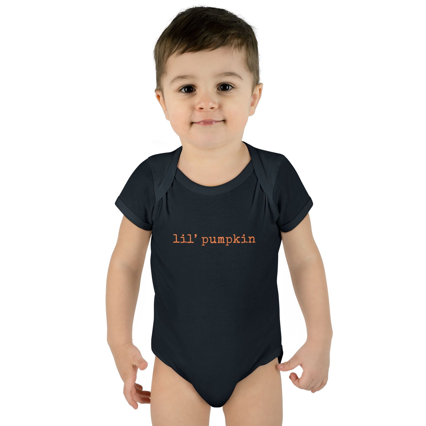 Child wearing a black onesie with 'lil' pumpkin' text on a white background