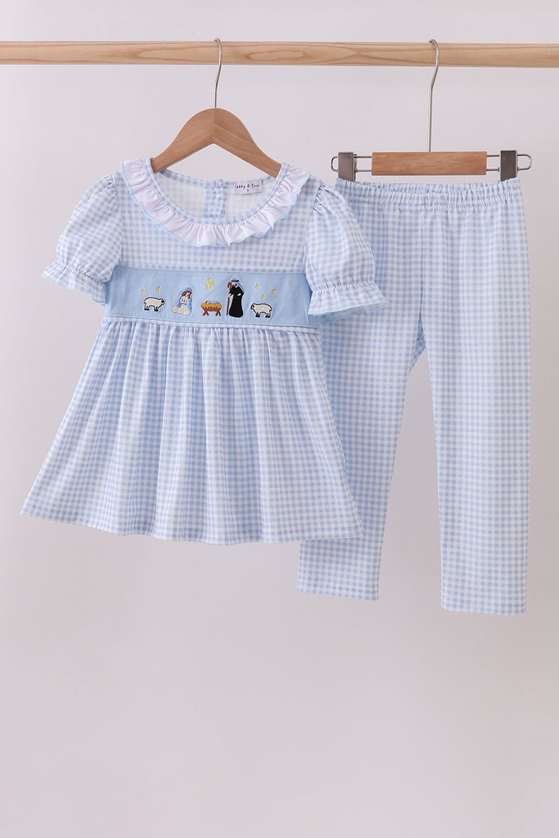 Children's blue checkered dress and pants set on a hanger against a light background