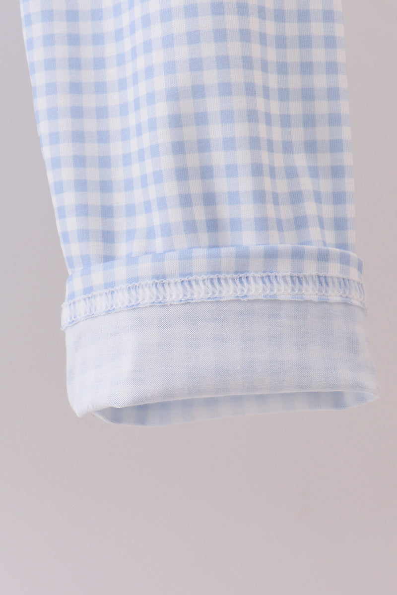 Close-up of a blue and white checkered fabric on a gray background