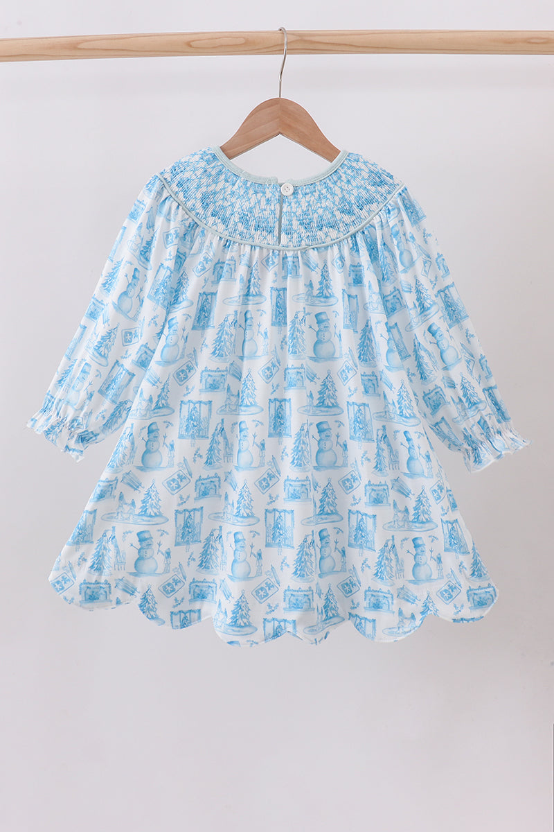 Blue patterned dress on a wooden hanger against a white background