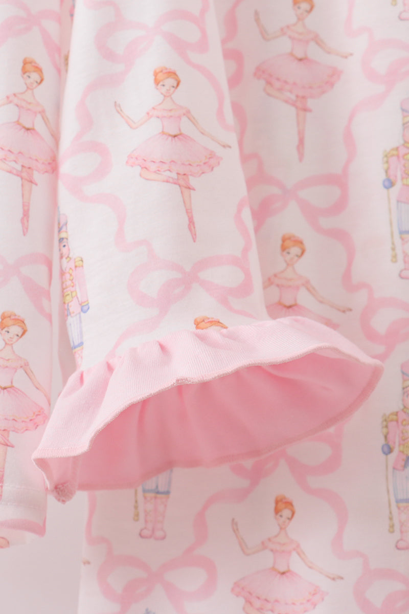 Pink dress with ballerina pattern on a matching background