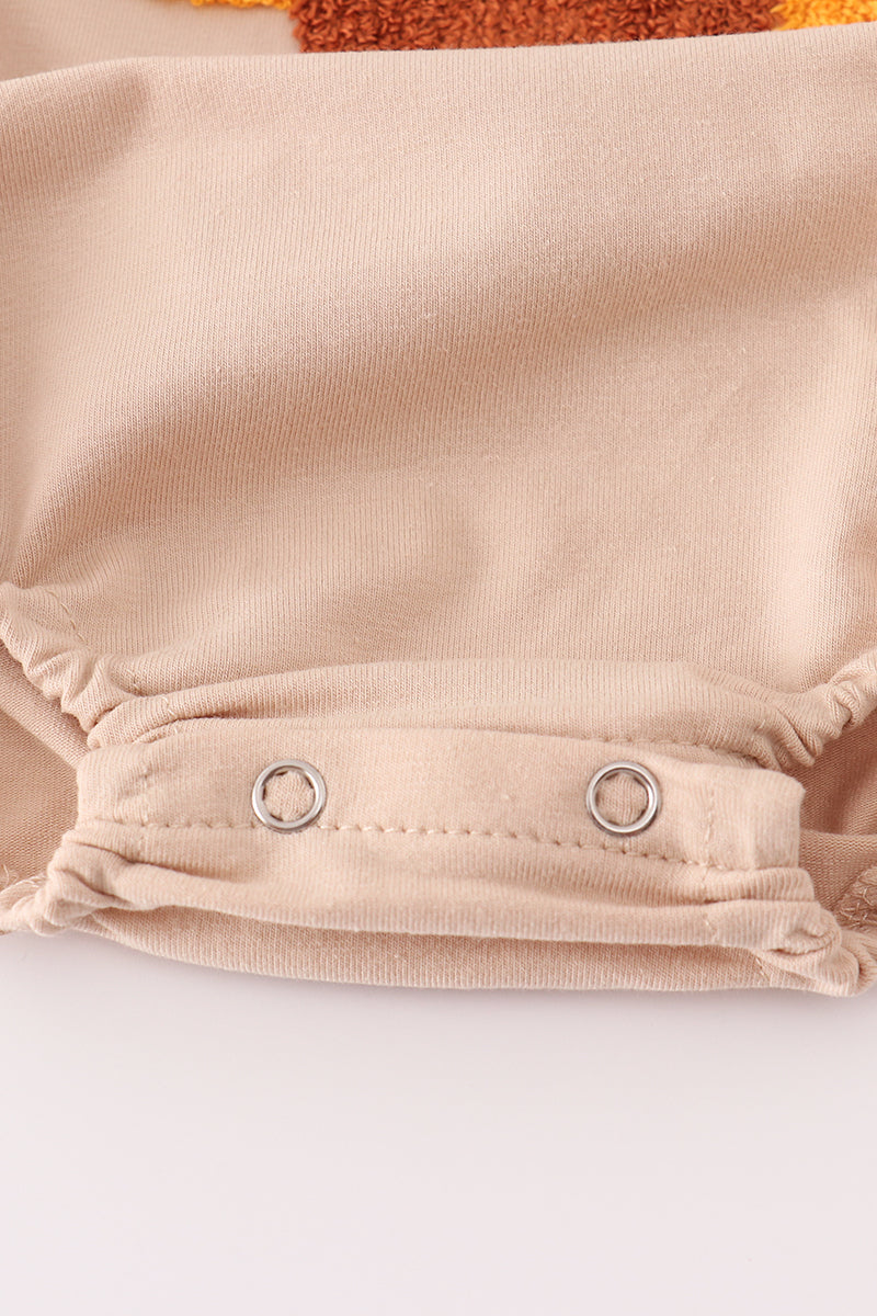 Close-up of beige fabric with metal grommets on a white background