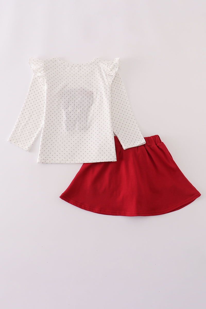 White long-sleeve top with a red skirt on a light gray background