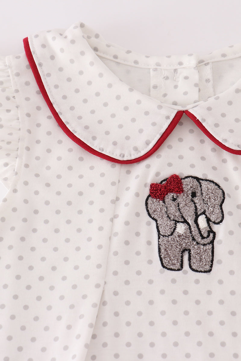 Children's outfit with polka dot pattern and embroidered elephant design on a white background