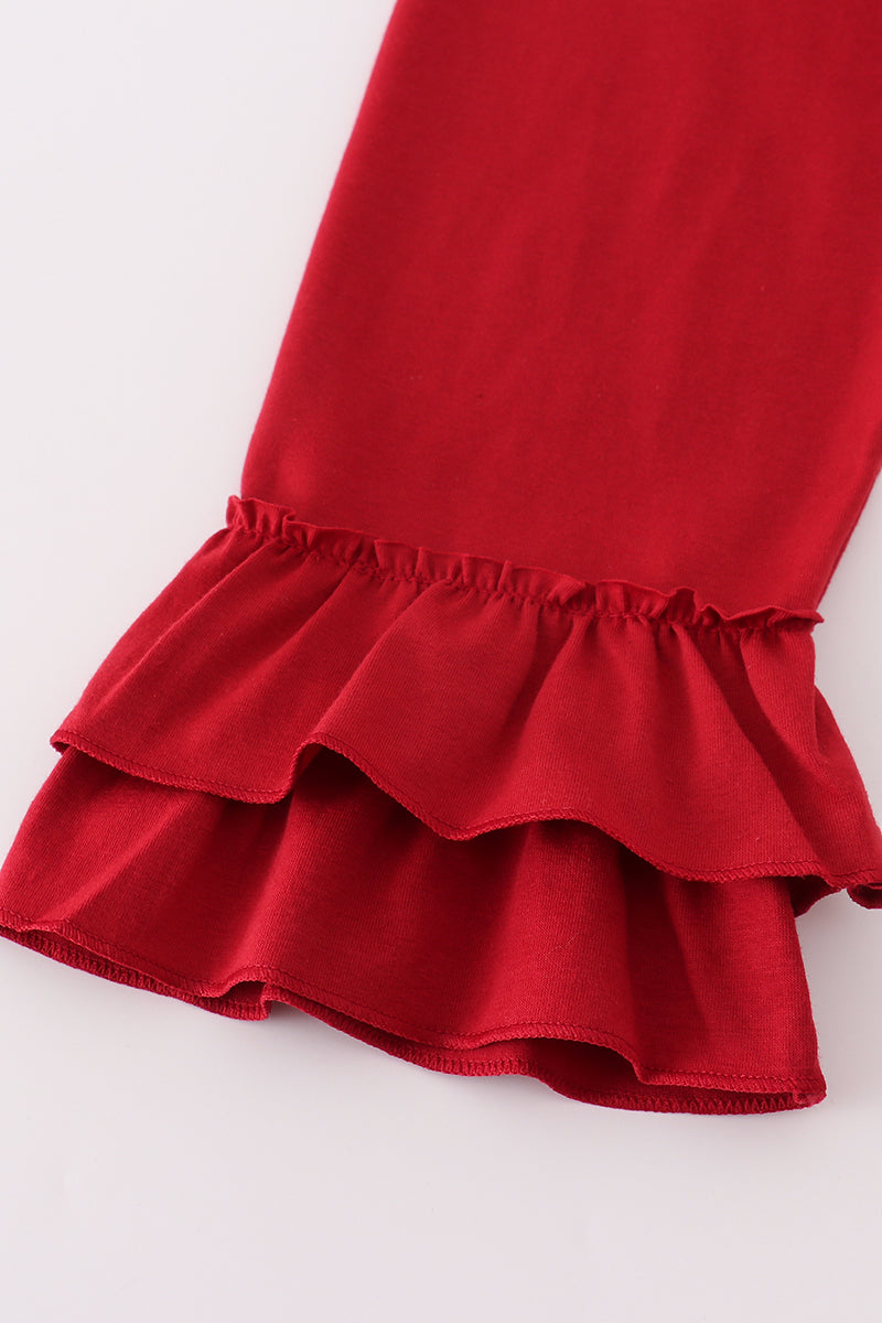 Close-up of a red ruffled skirt on a white background