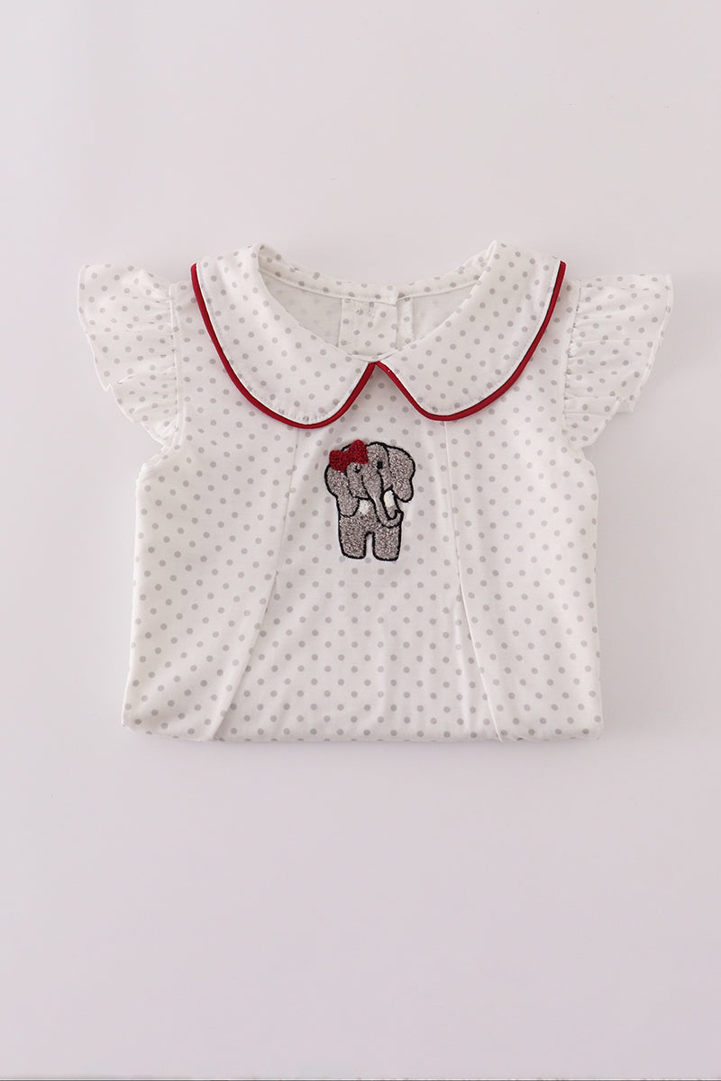 White baby dress with red collar and elephant design on a light gray background