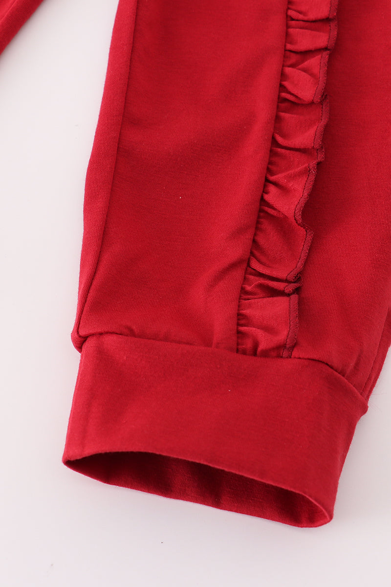 Close-up of a red fabric with ruffled edge on a white background