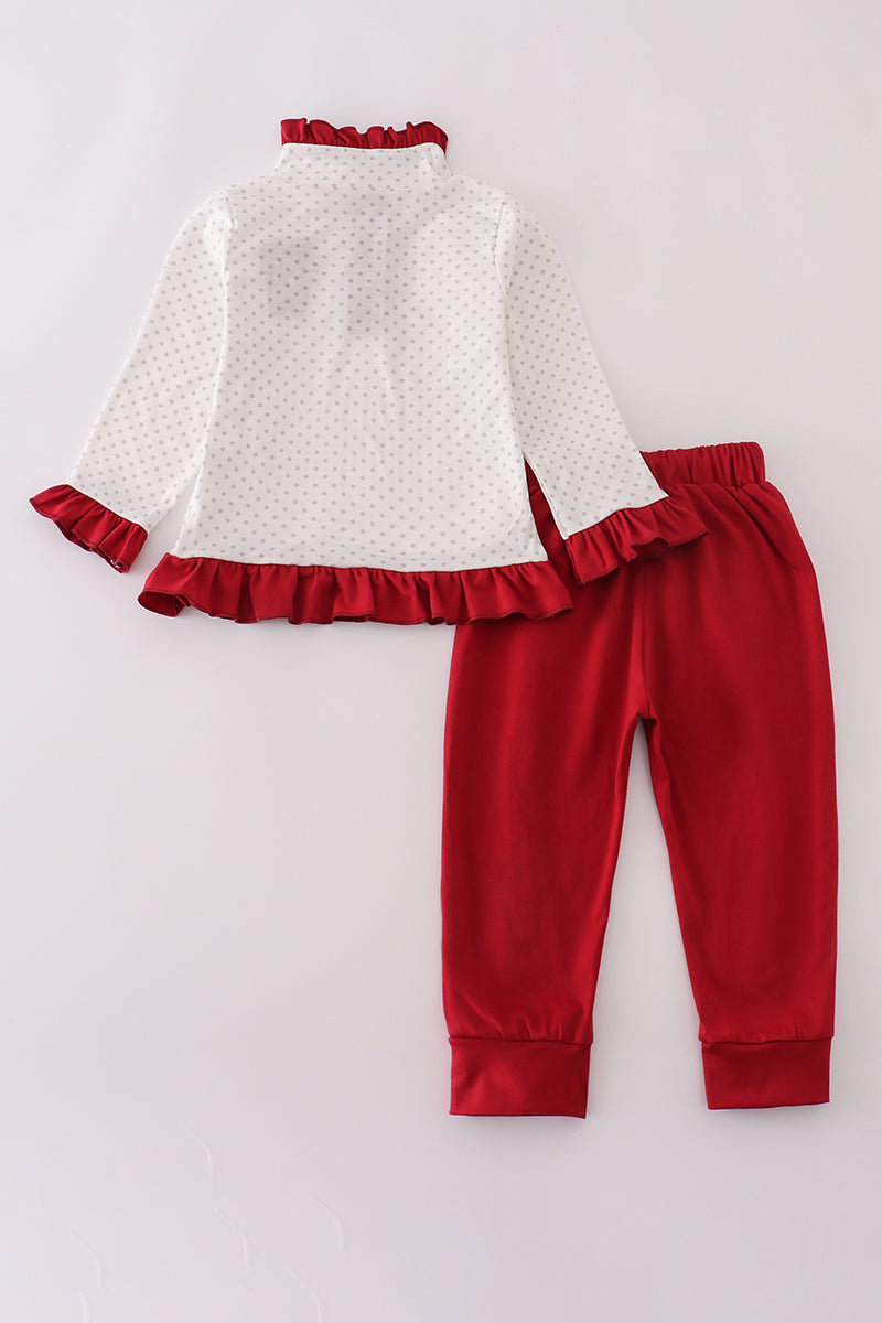 White top with red ruffles and matching red pants on a white background