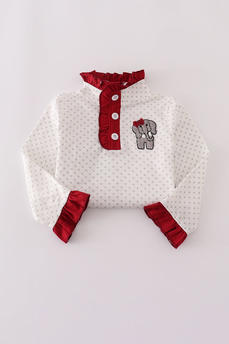 White baby outfit with red accents on a light gray background