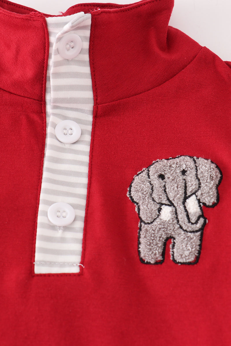 Red garment with a gray elephant patch and button details on a white background