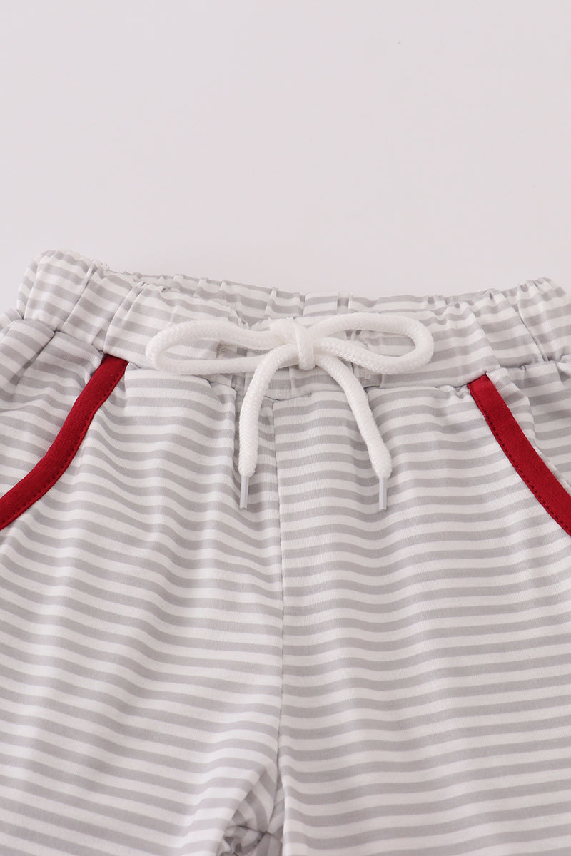 Striped shorts with red trim on a light gray background