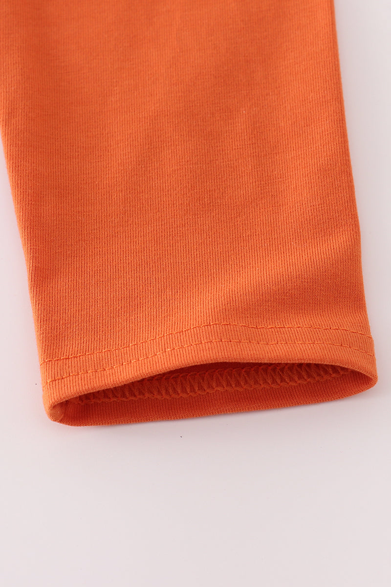 Close-up of an orange fabric roll on a white background