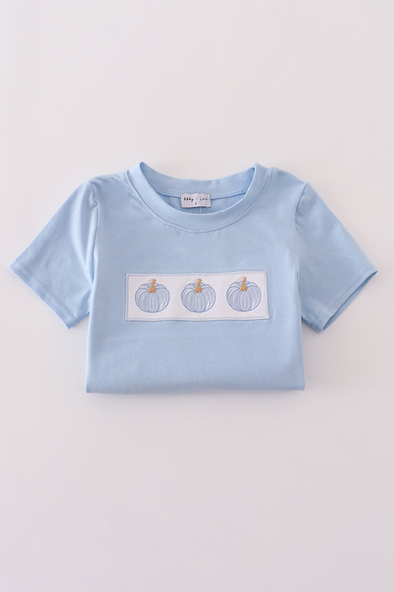 Light blue t-shirt with a graphic of three pumpkins on a light gray background