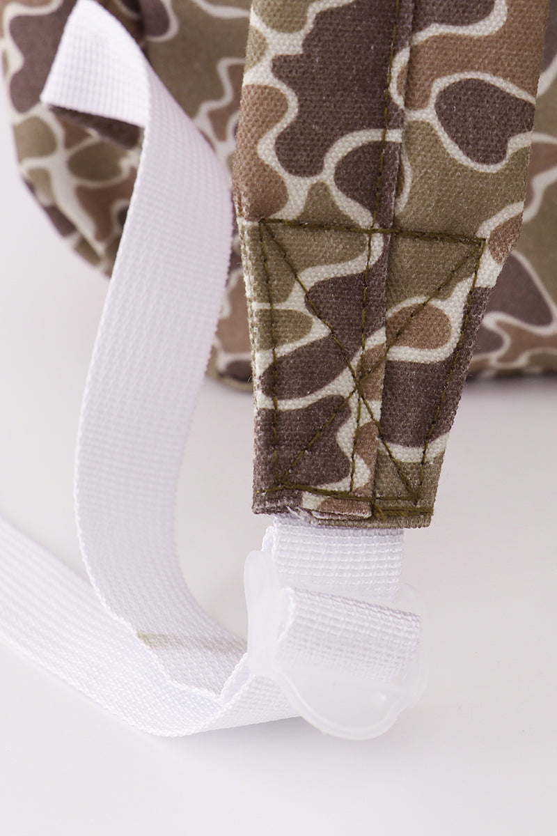Camouflage pants with white socks on a light background
