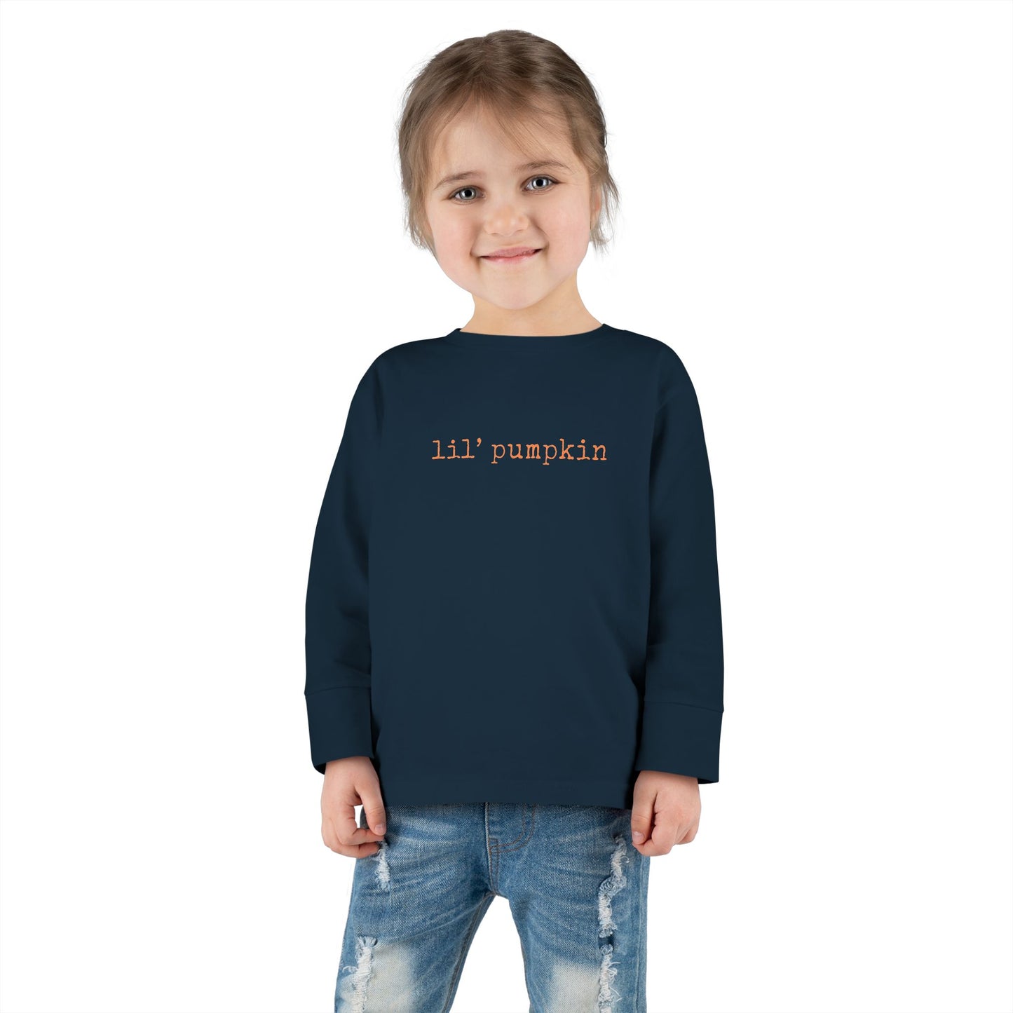 Child wearing a navy blue sweatshirt with 'lil' pumpkin text on a white background