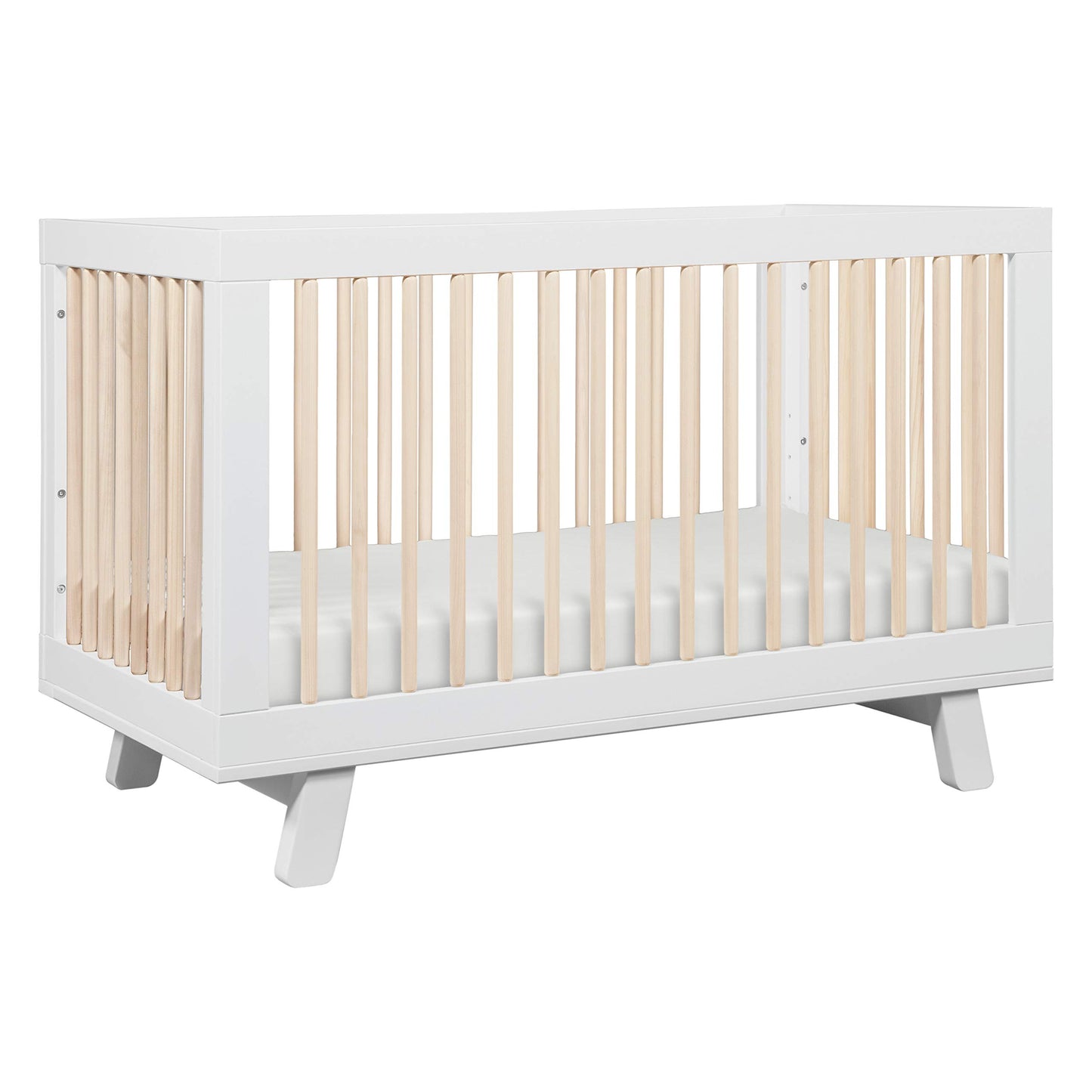 White crib with light wood slats on a white background