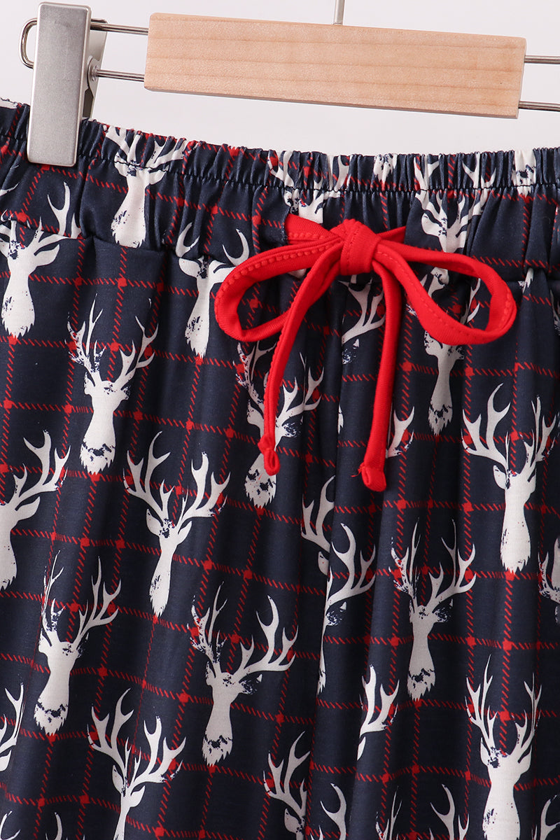 Plaid pants with deer pattern and red drawstring on a hanger.