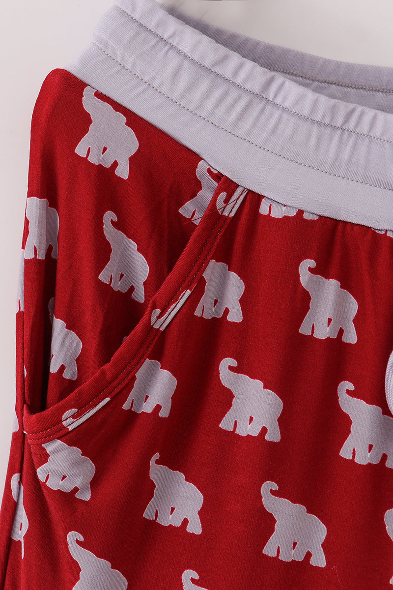 Red shorts with white elephant pattern on a plain background