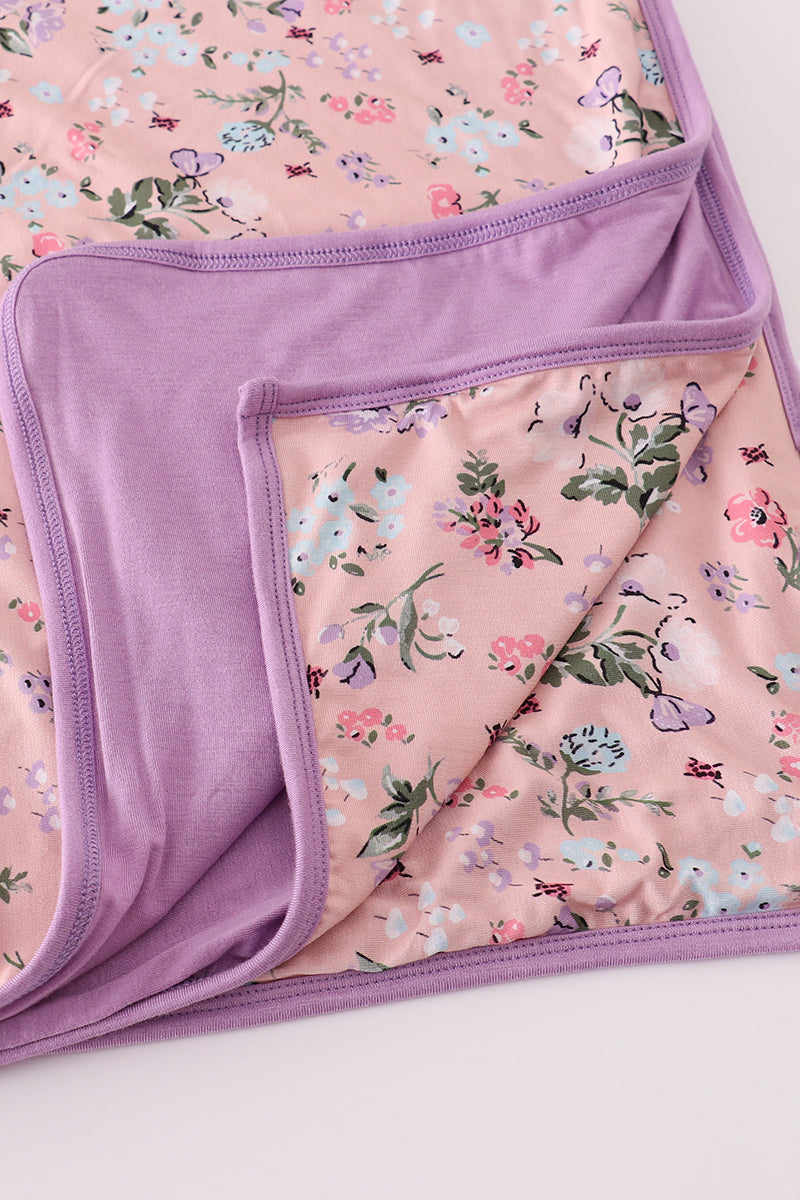 Floral-patterned blanket with a purple border on a white background