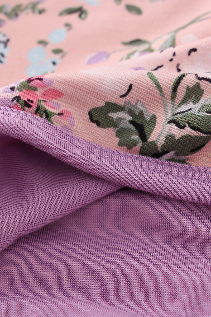 Close-up of pink floral fabric with a purple border