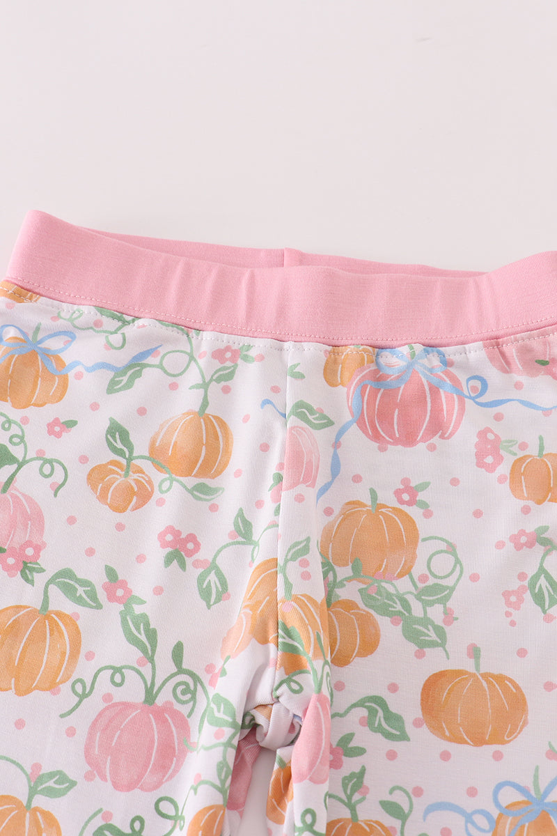 Pajama pants with pumpkin and floral pattern on a white background