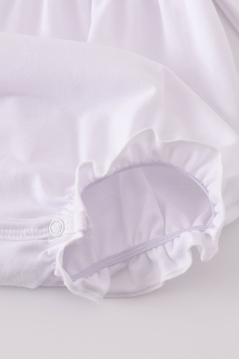 White blouse with ruffled collar on a light background