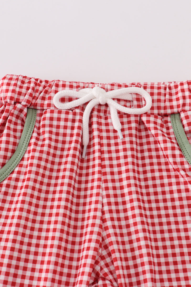 Red and white checkered shorts with a drawstring on a light gray background