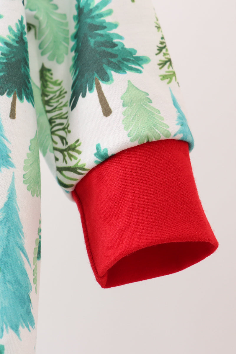 Close-up of a red cuff on fabric with green tree pattern