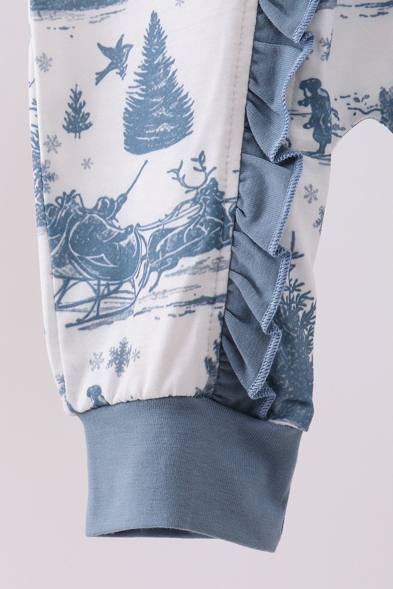 Baby romper with winter scene print and ruffled details on a light background