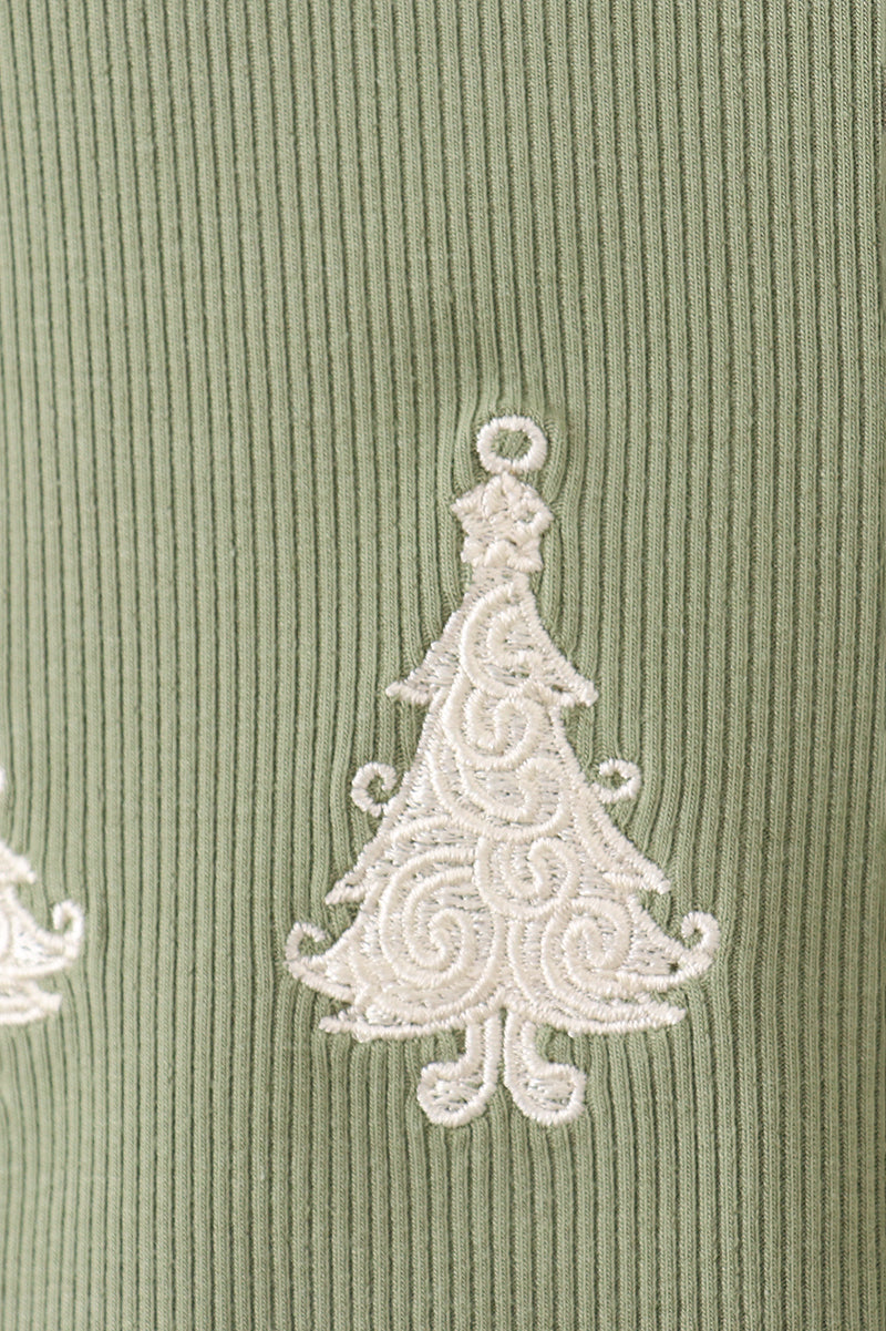 Decorative white tree design on a green textured fabric background