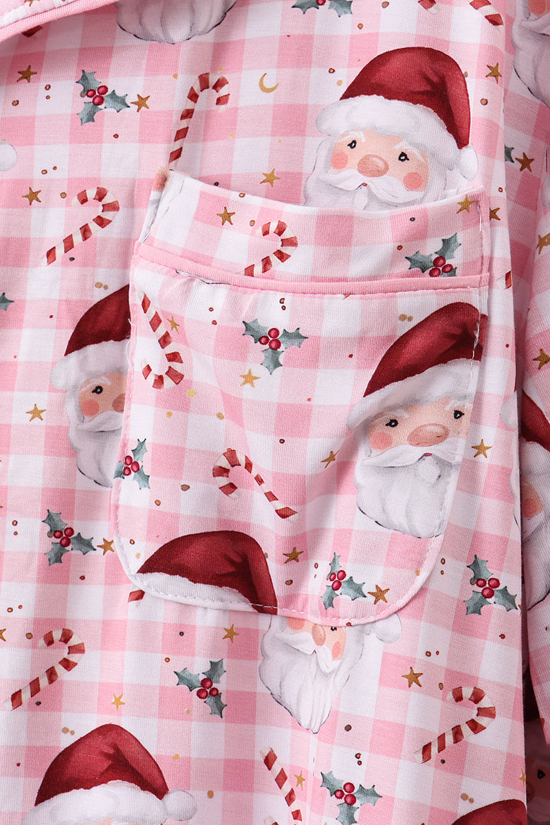 Pink checkered fabric with Santa Claus design and candy canes on a pink background