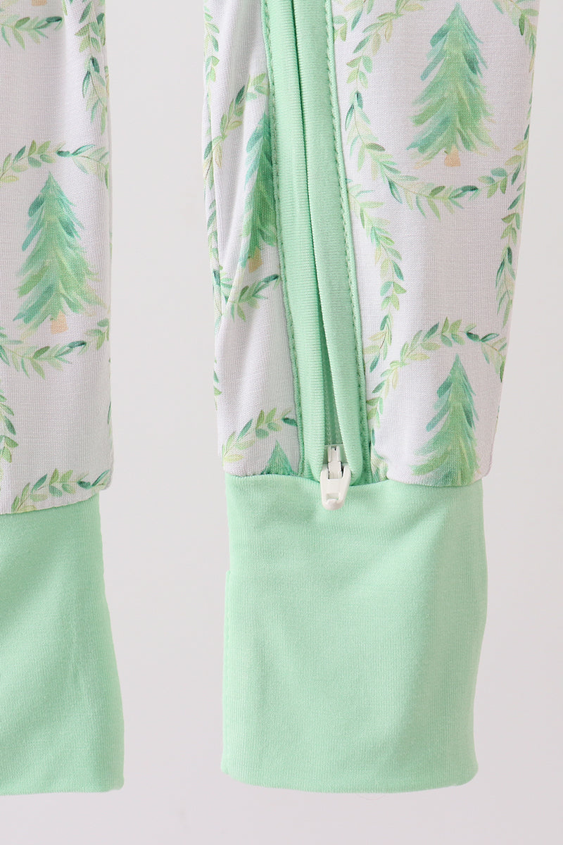 Light green and white fabric with tree pattern on a plain background
