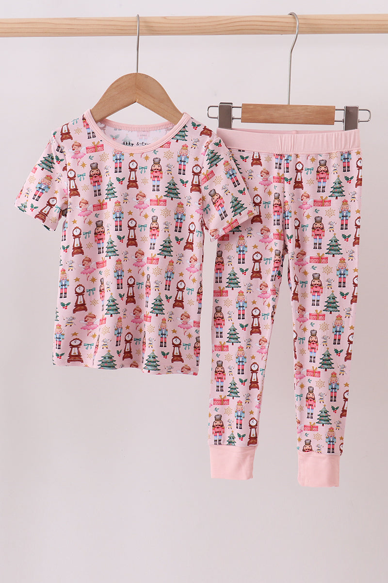 Children's pajama set with Christmas pattern on a hanger against a light background