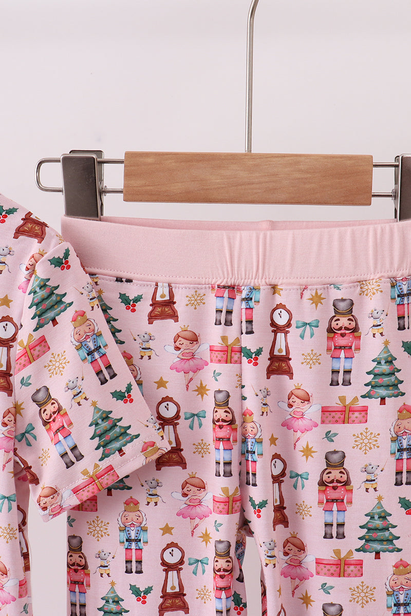 Pink skirt with Christmas-themed pattern on a hanger against a white background