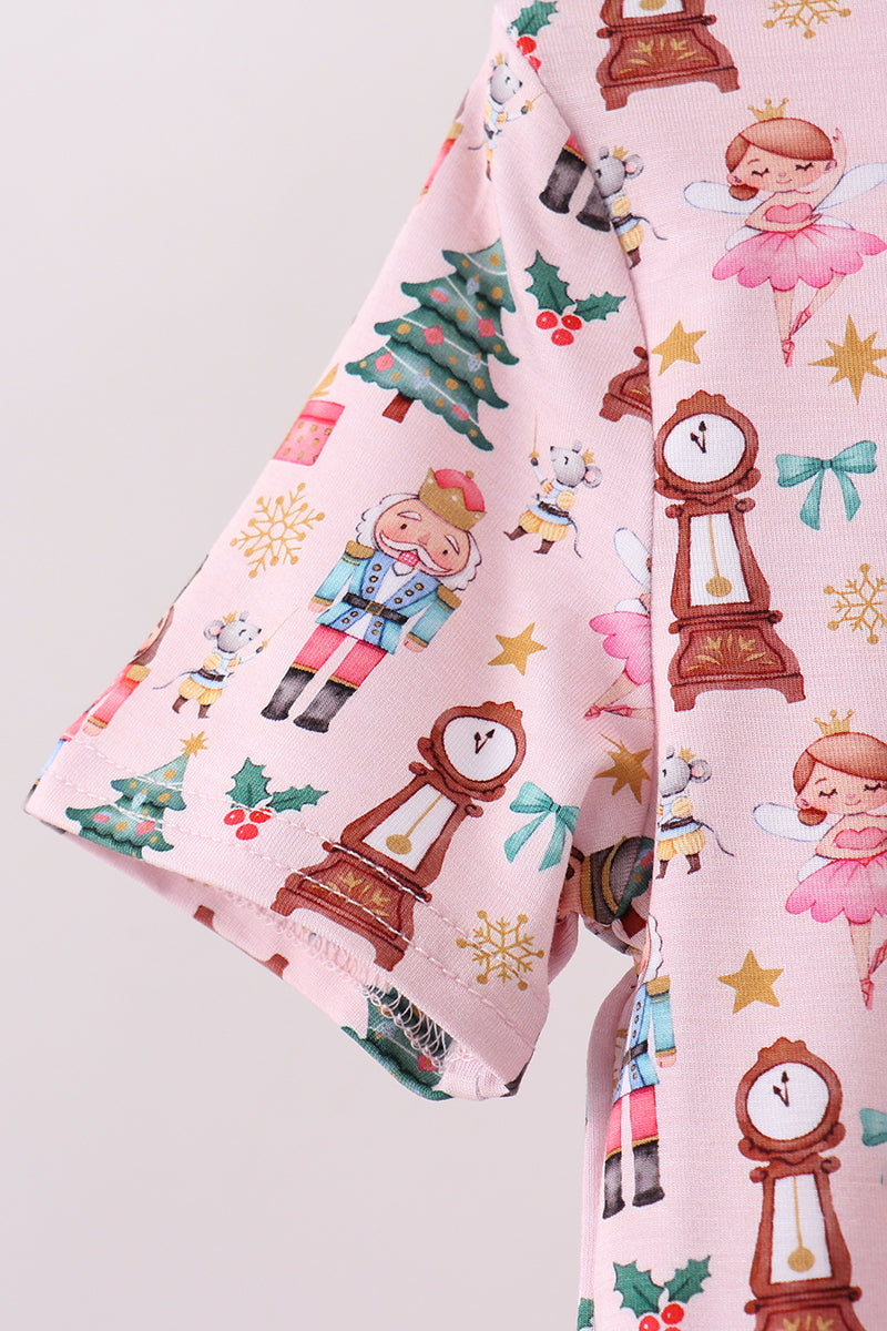 Fabric with Christmas-themed design featuring clocks, trees, and children on a pink background.