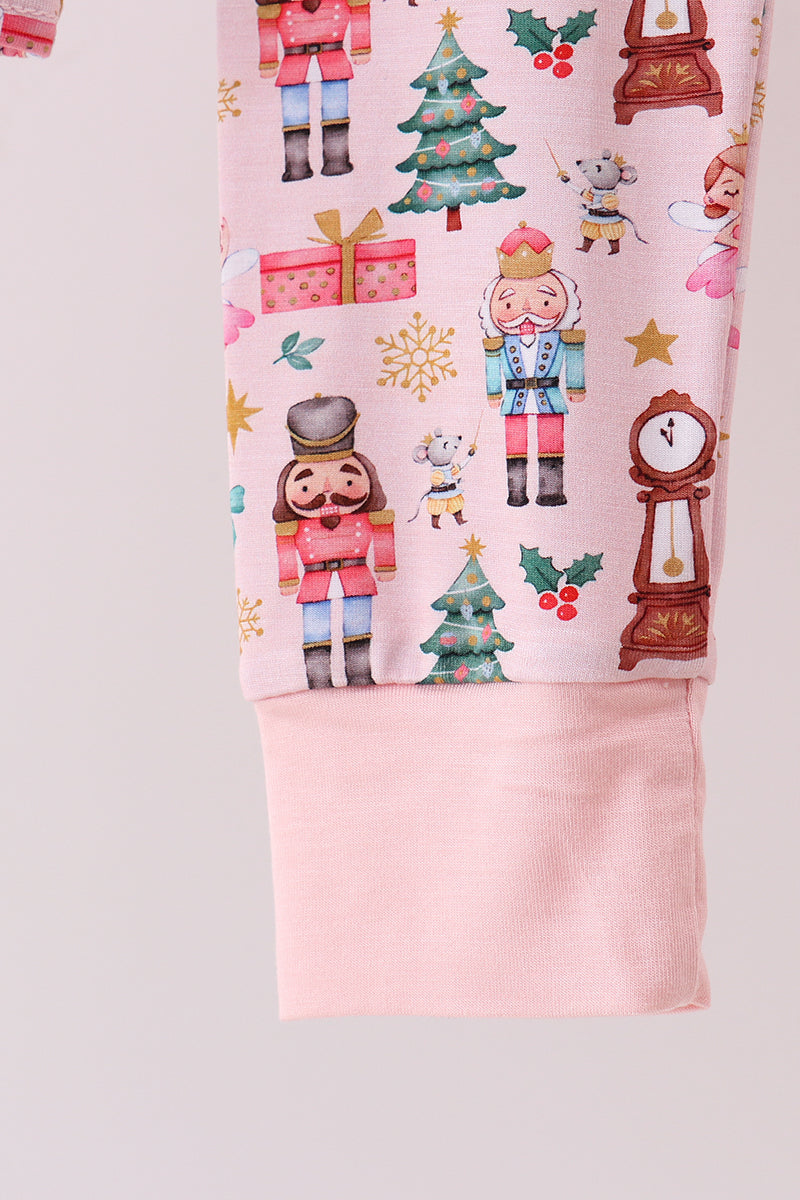 Pink pajama set with Christmas-themed design on a light gray background