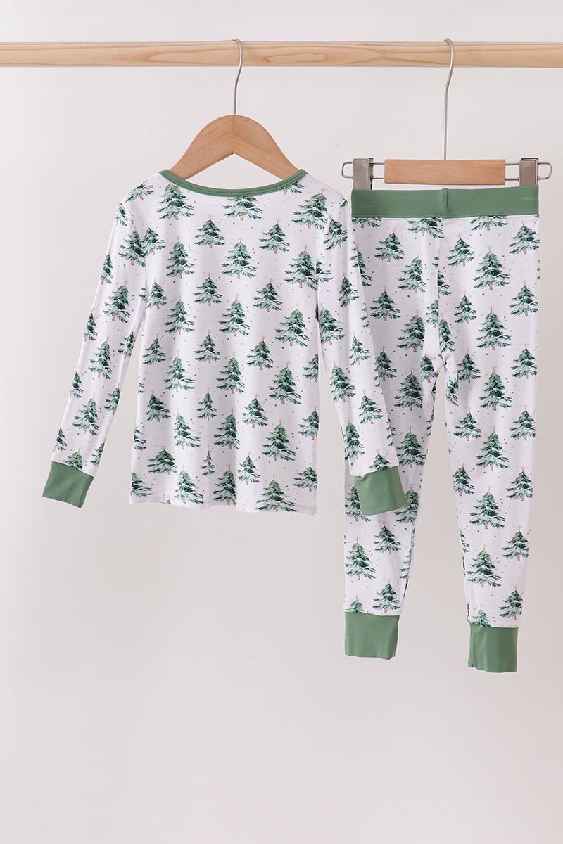 Children's pajama set with tree pattern on a hanger against a white background