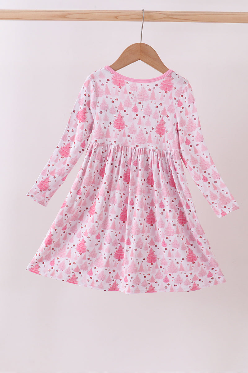 Pink floral dress on a hanger against a white background