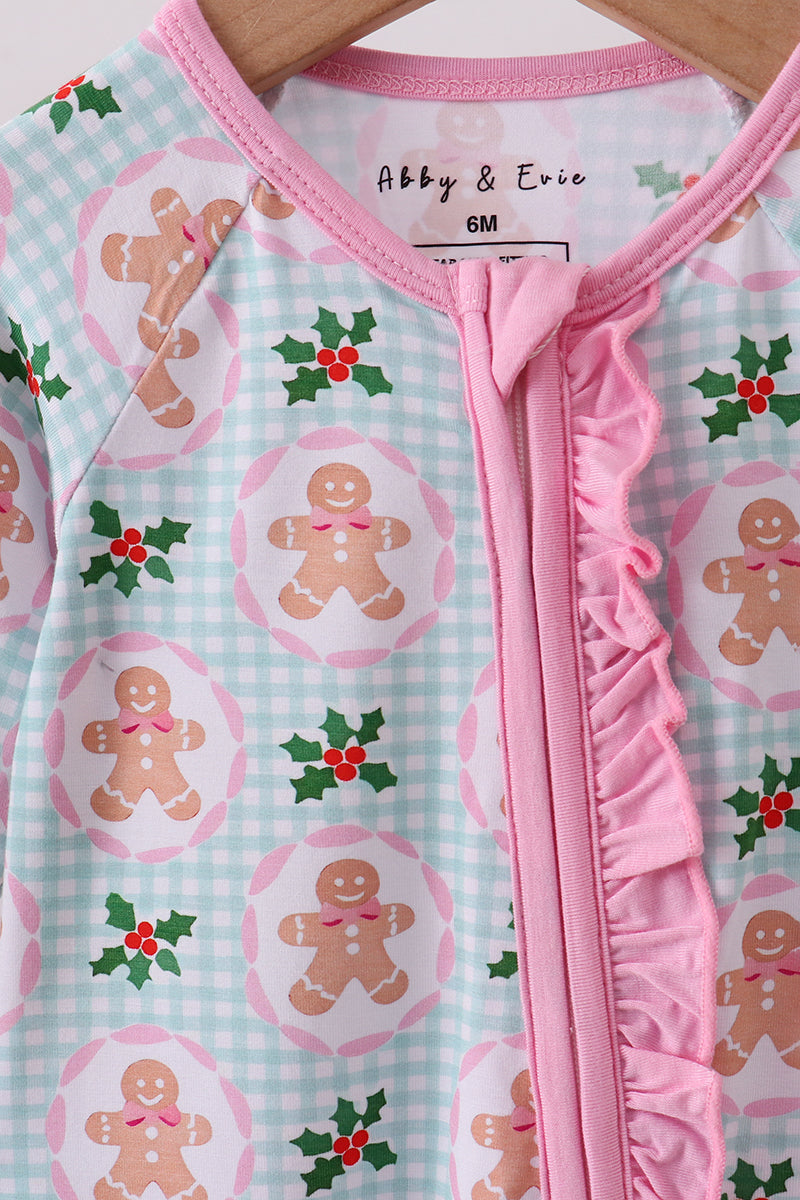 Baby onesie with gingerbread man and holly design, brand 'Abby & Eric' visible.