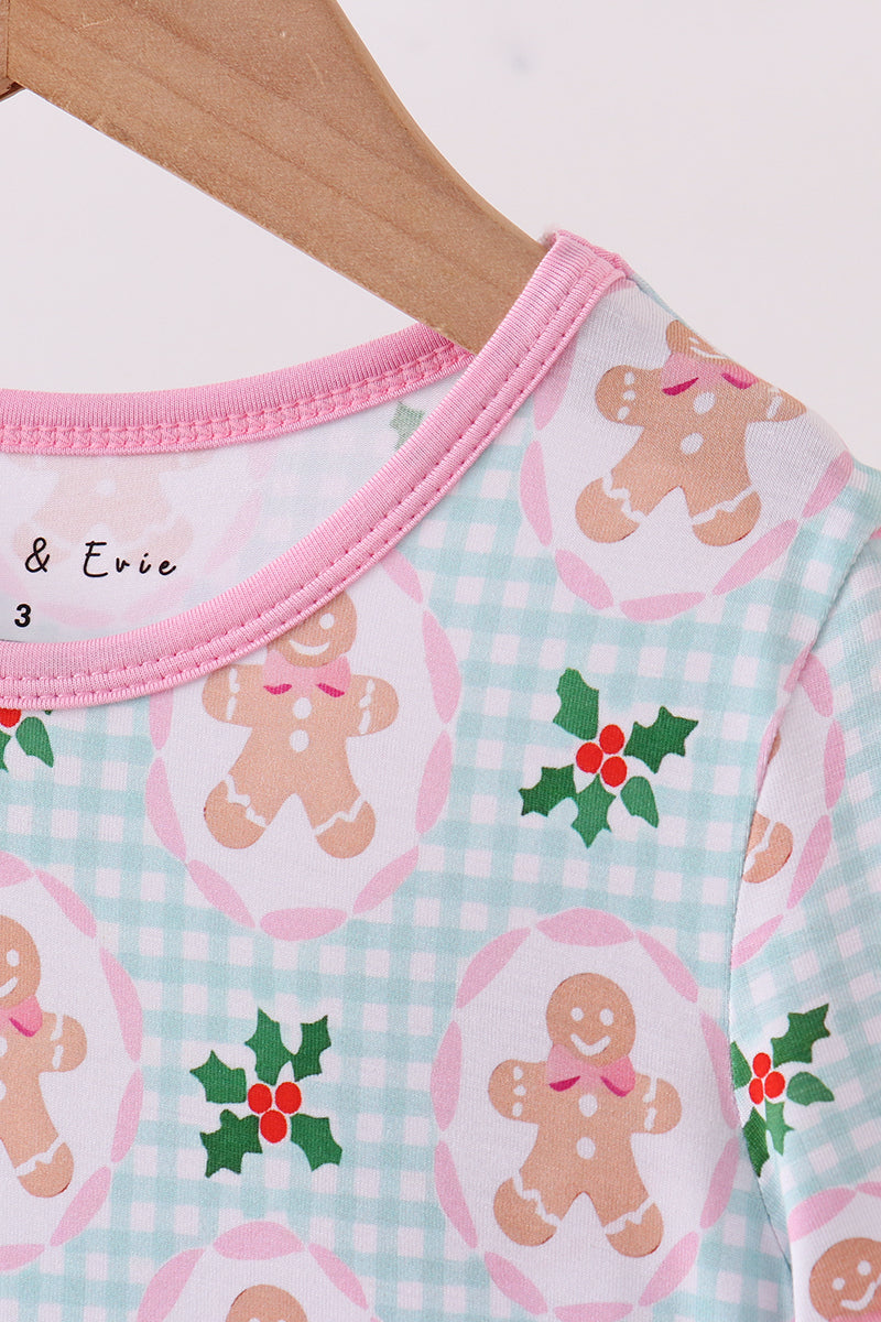 Baby onesie with gingerbread man and holly design on a white background