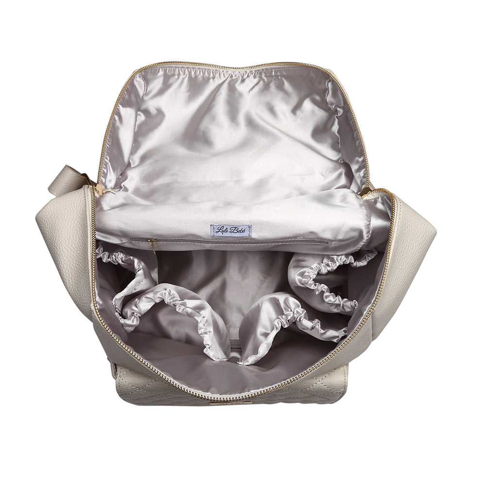 Backpack with silver interior and visible brand logo on a white background