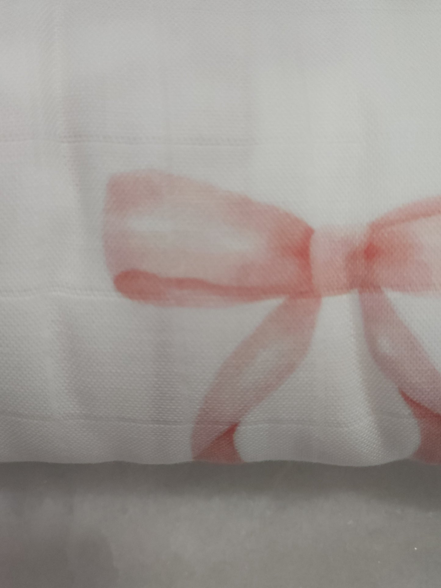 Red bow on a white fabric background