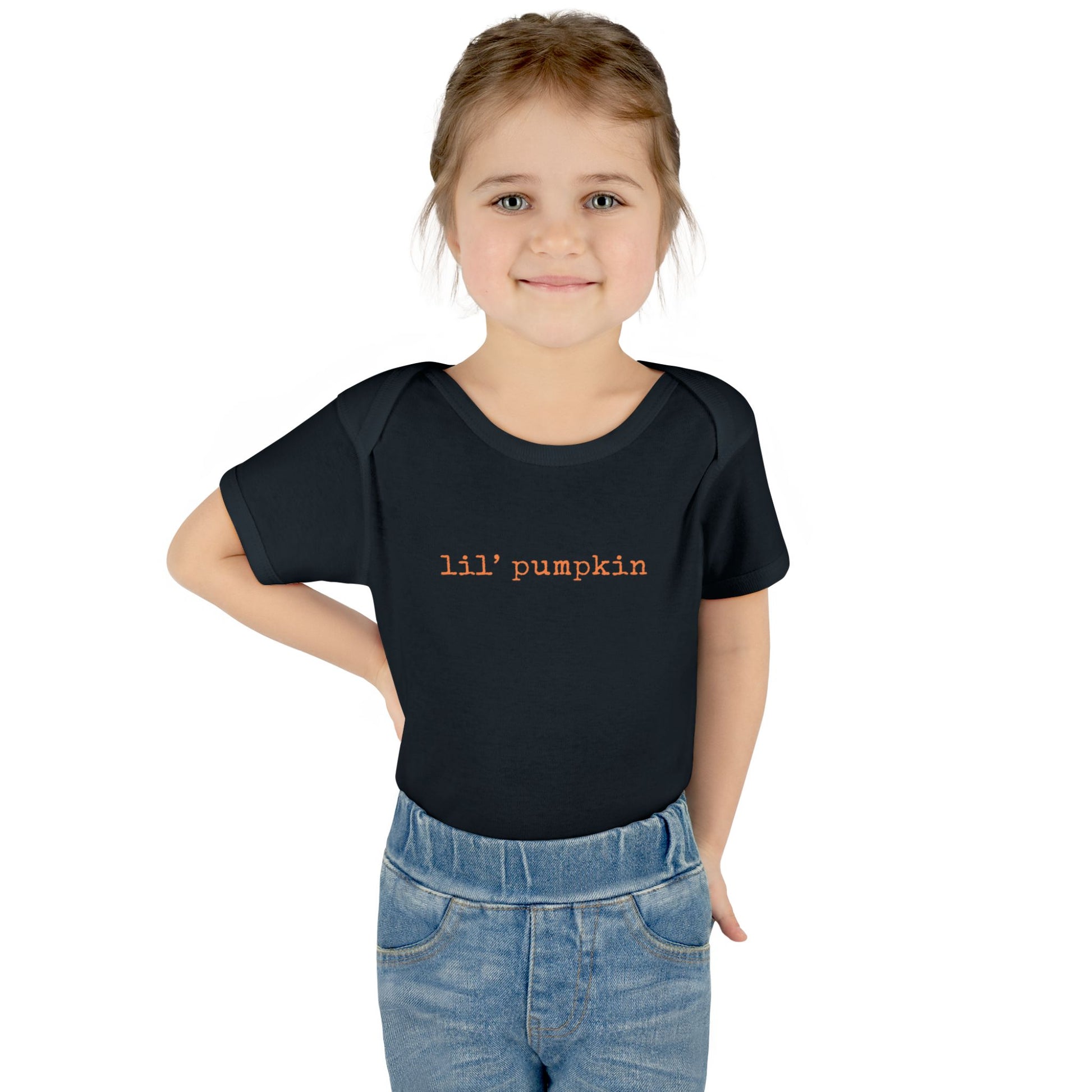 Child wearing a black t-shirt with 'lil' pumpkin' text on a white background