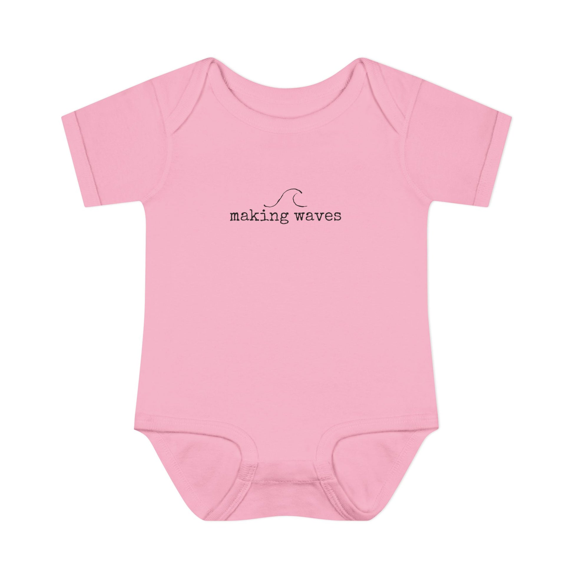 Pink baby onesie with 'making waves' text on a white background