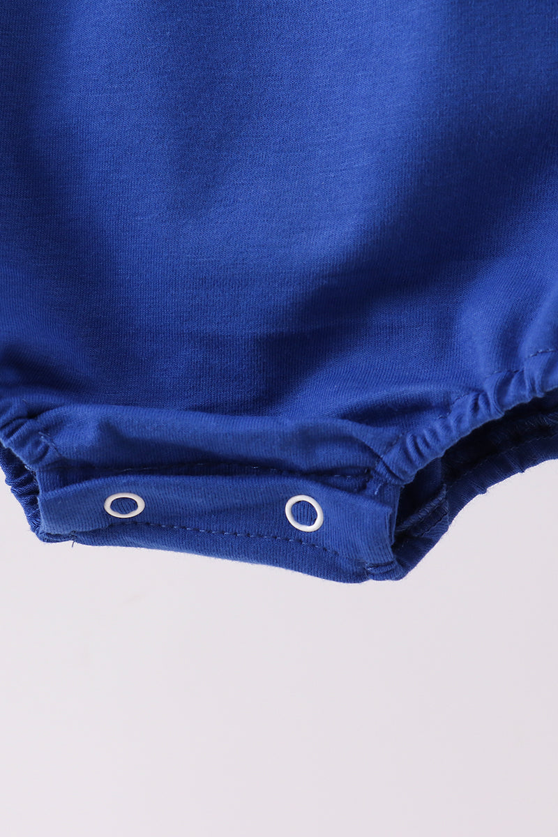 Close-up of a blue baby romper with a plain background