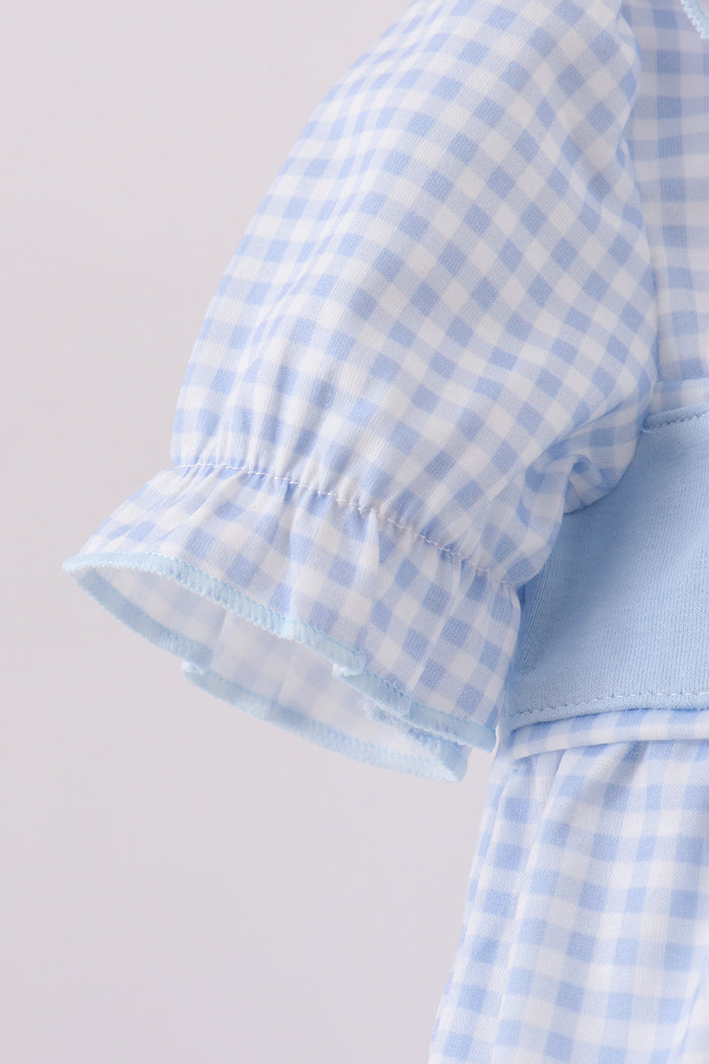 Light blue and white checkered dress with ruffled sleeves on a light gray background