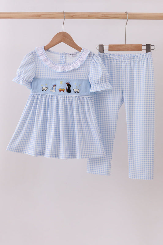 Children's blue checkered dress and pants set on a hanger against a light background