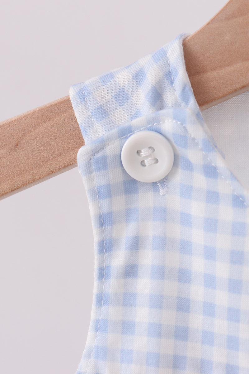 Baby romper with blue and white checkered pattern on a wooden hanger