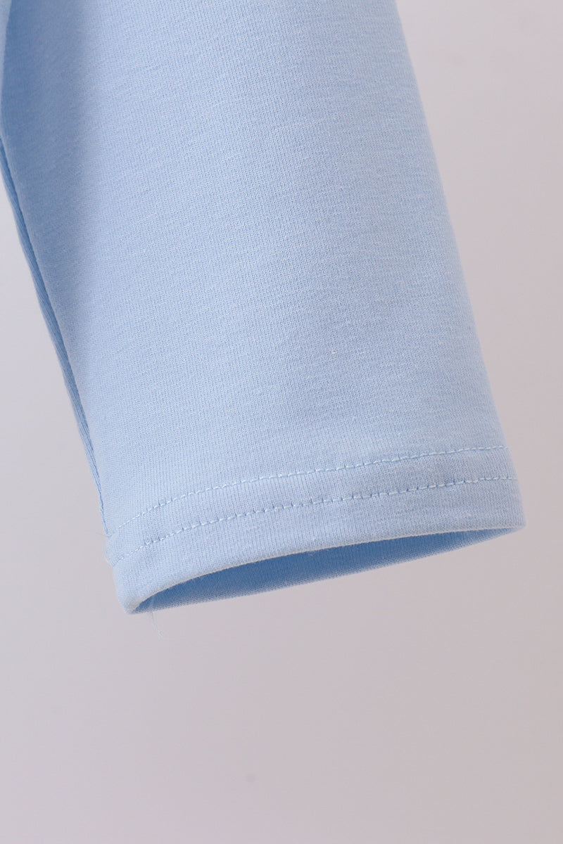 Close-up of light blue fabric on a plain background
